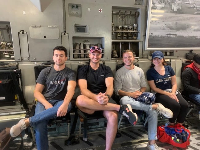 Four FLEX Medical Student cohort sitting in an AC130 at AirExpo Charleston
