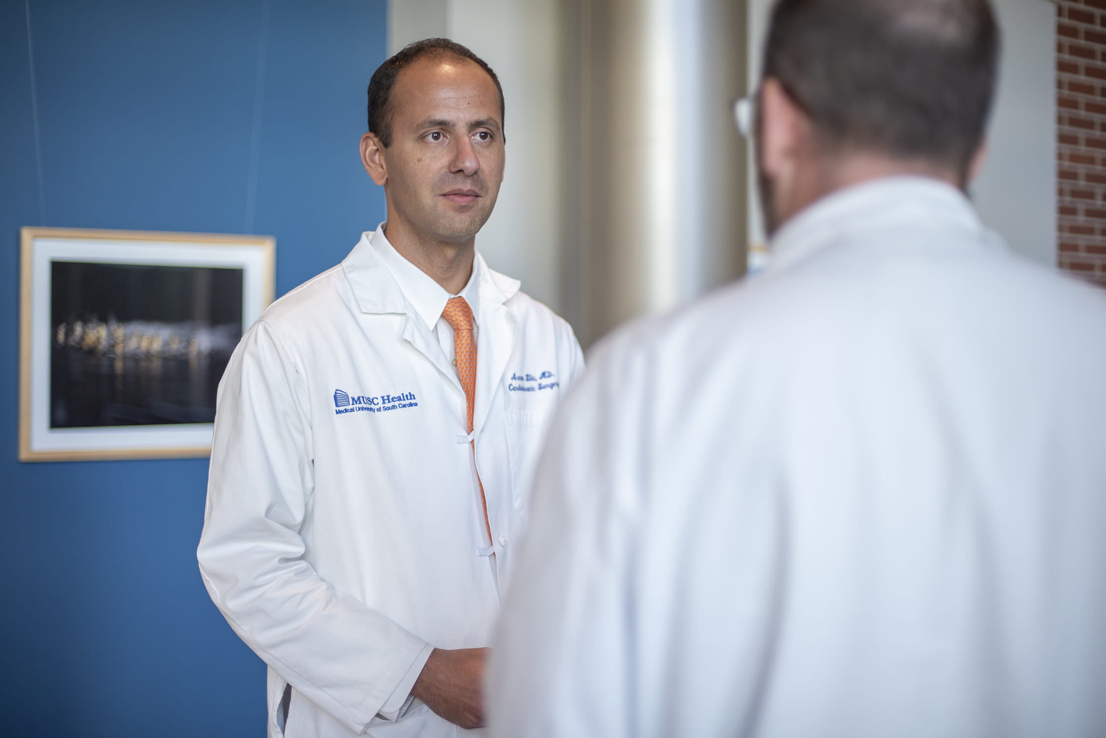 Arman Kilic, M.D., speaking with a colleague