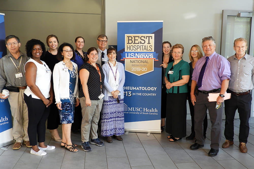 Rheumatology faculty with USNWR banner