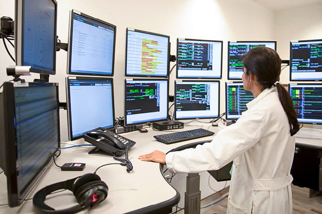 Physician viewing ICU monitors.