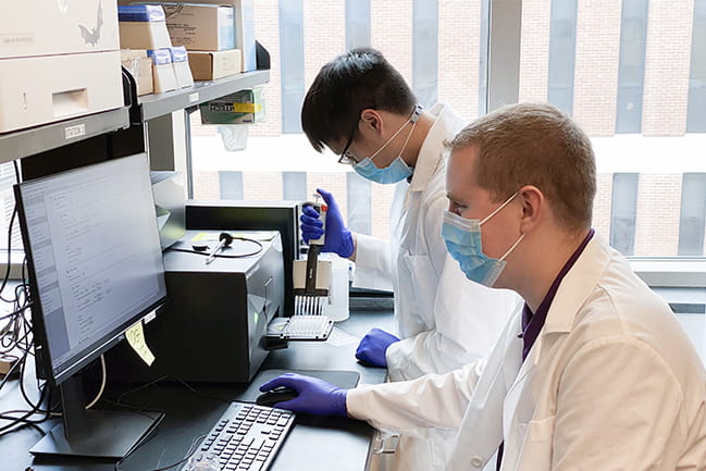Mark Domondon and Ryan Schibalski, research technicians in Ilatovskaya lab, performing spectrofluorimetry of mitochondria isolated from the kidneys of rats with high blood pressure.