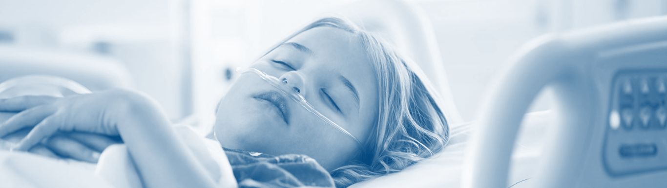 Photo of young child in hospital bed with an oxygen tube