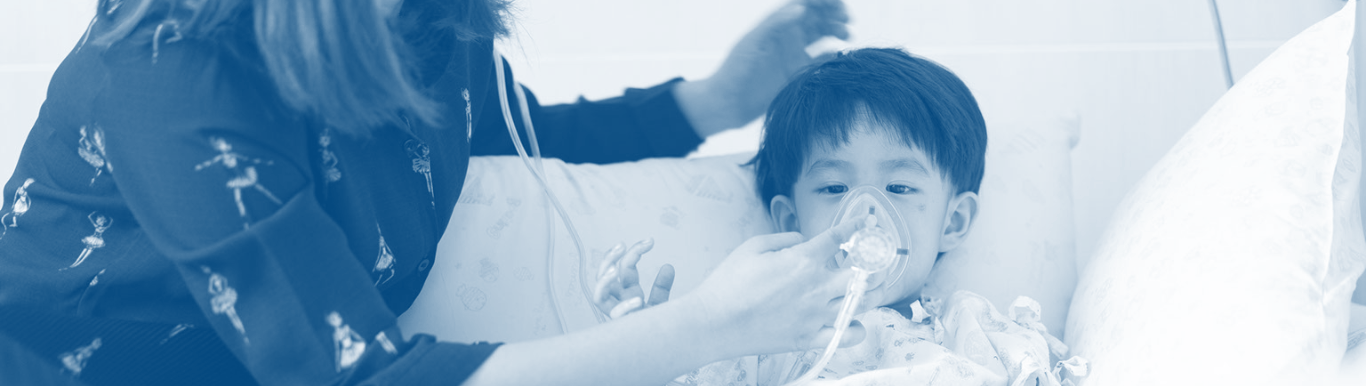 Photo of young child with oxygen mask on in an emergency room