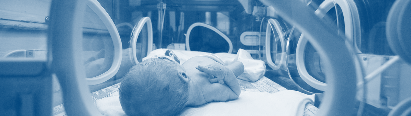 Photo of a premature infant in a NICU incubator