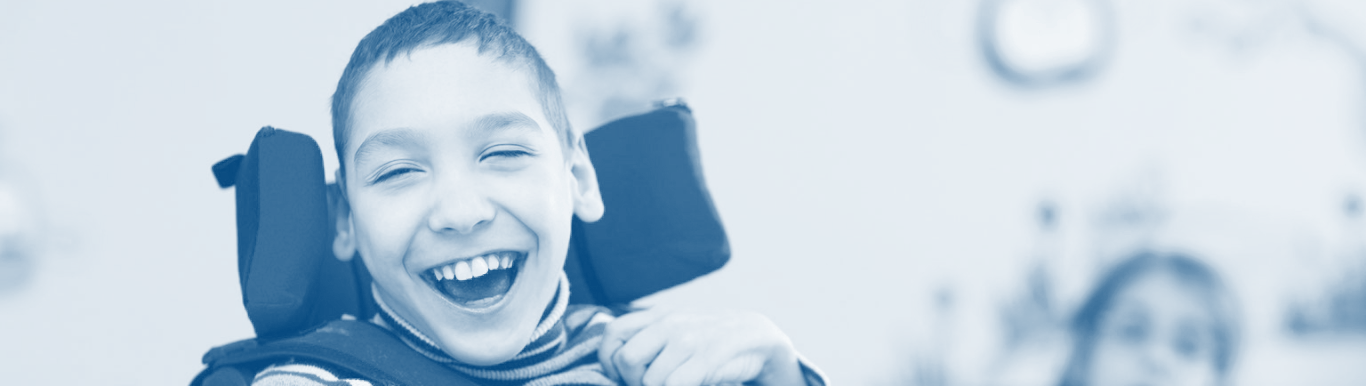 Photo of child smiling in wheel chair with cerebral palsy disorder