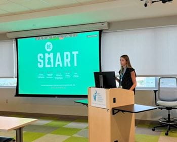 Katie Lants presenting Be SMART Warm Up Presentation for our Summer Advocacy Lecture Series