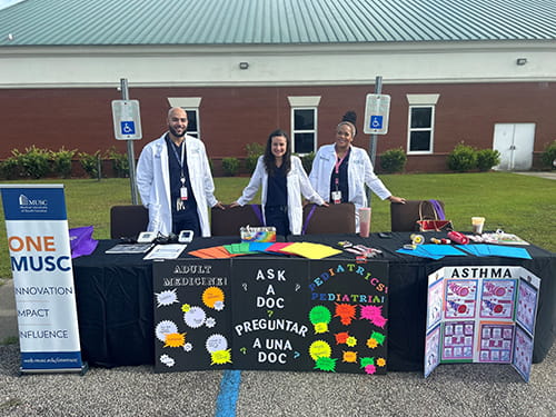 Med-Peds Ourtreach at an outside table