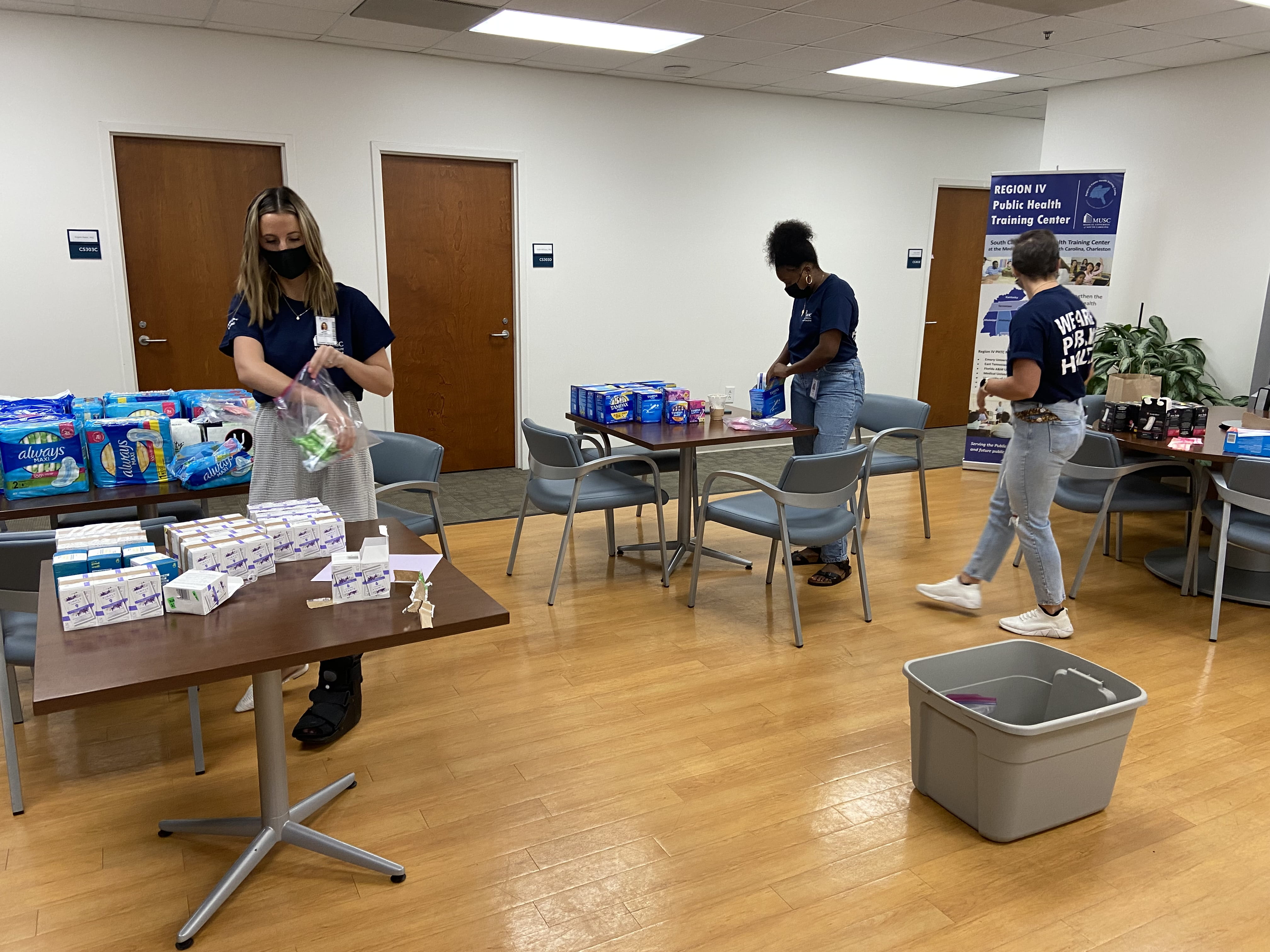 MUSC MPH students pack feminine hygiene packs for homeless shelters.