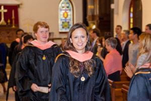 Two new MPH graduates smile as they recess from the 2017 MPH hooding ceremony