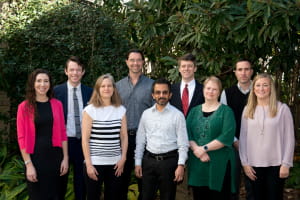 Group picture of the faculty of the Collaborative Unit outside in front of a magnolia tree