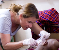 Female public health worker examines patient