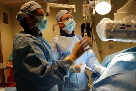 Two clinicians conducting procedure