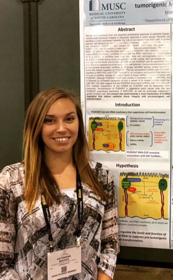 Catherine standing by her poster