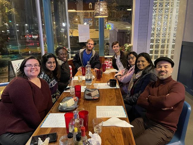 Kourtidis lab celebrating Christmas at dinner