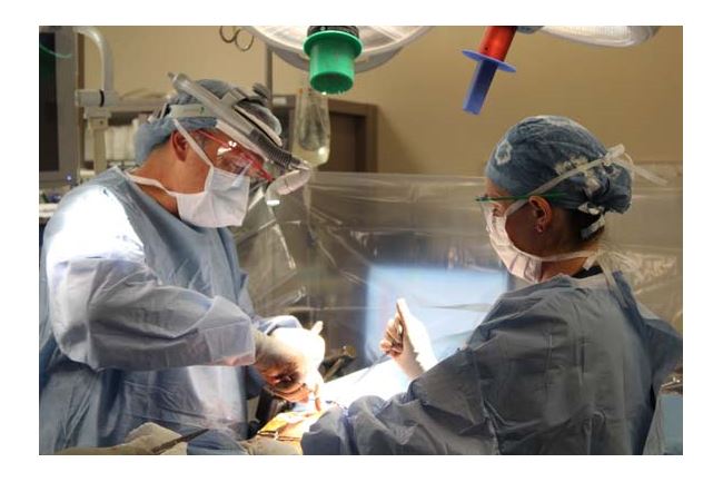 Dr, Evert Eriksson, trauma surgeon, repairing a patient's rib with a rib fixation device. 