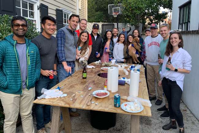 Urology residents around a table at an Oyster Roast.