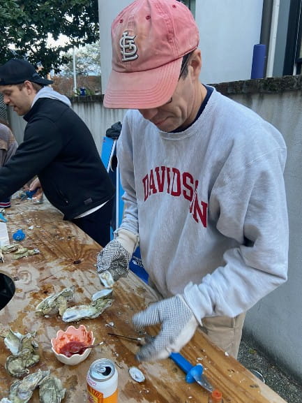 Urology resident pouring oysters on a table.