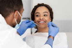 dentist looking at patient's teeth
