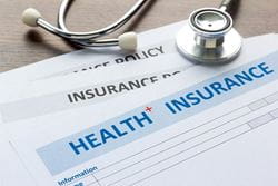 health insurance forms with stethoscope