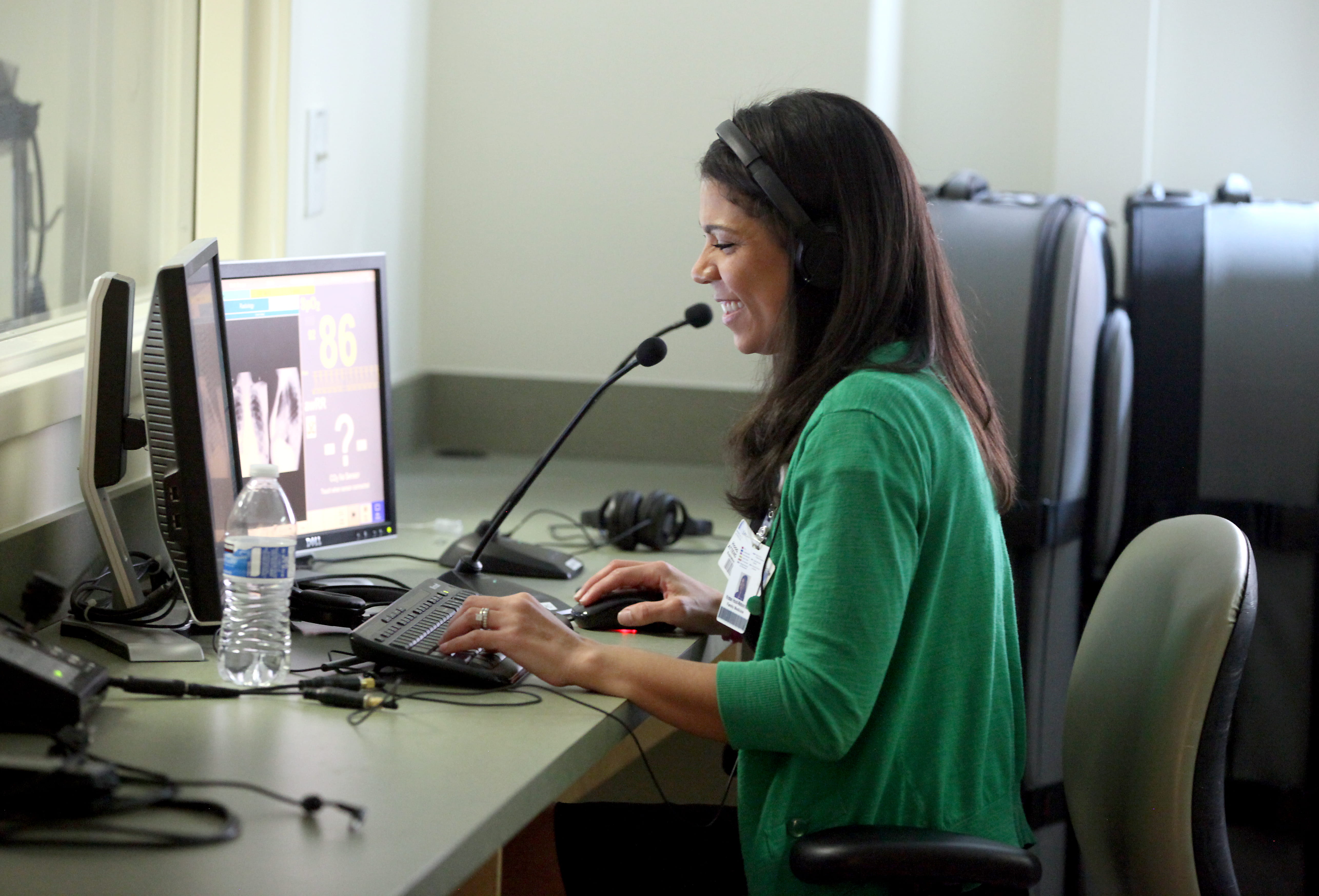 Dr. Hood-Watson smiling while in the Sim Lab