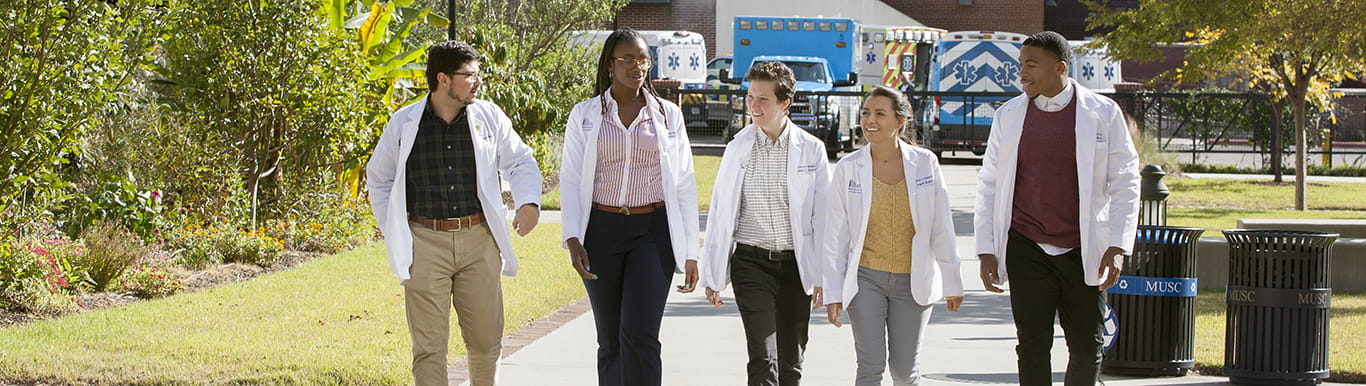Five College of Medicine students walking the campus.