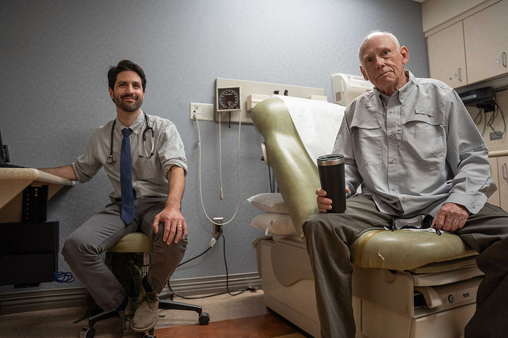 Dr. Brian Hess and William Donevant sit in an exam room