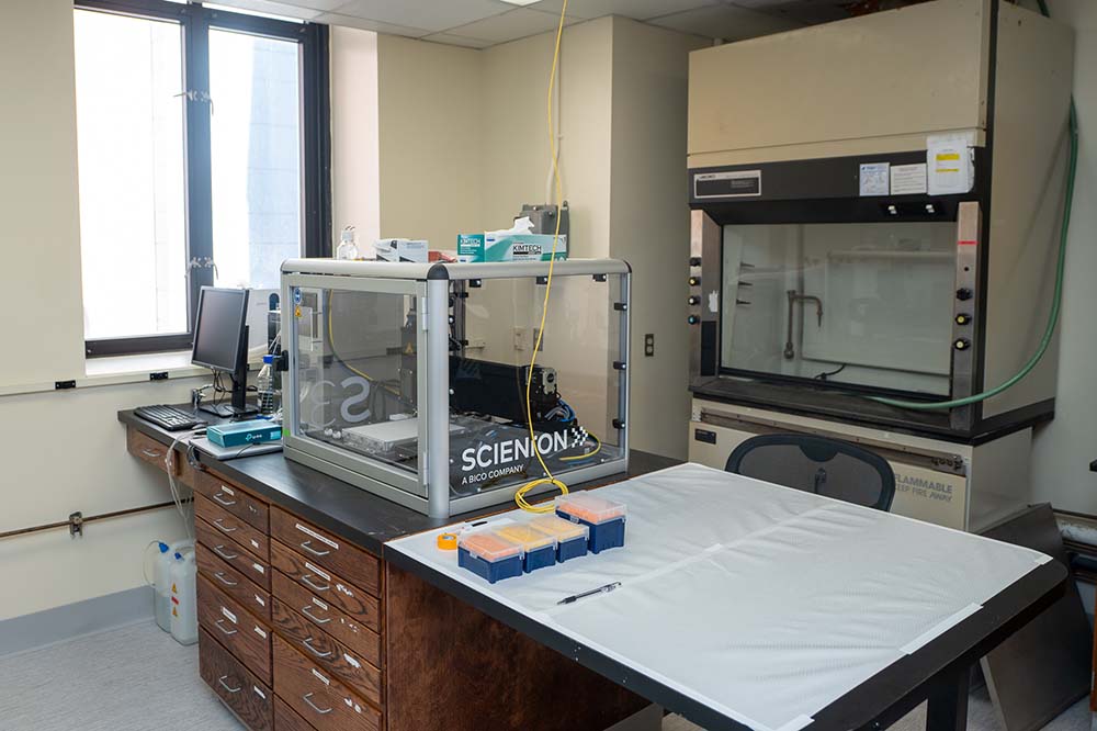 Laboratory equipment on countertops with cabinets below.